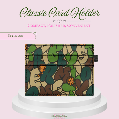 A classic card holder wallet with a green, brown, and beige camouflage pattern featuring cartoon monkey illustrations, displayed on a white tiered pedestal against a light pink background with promotional text.