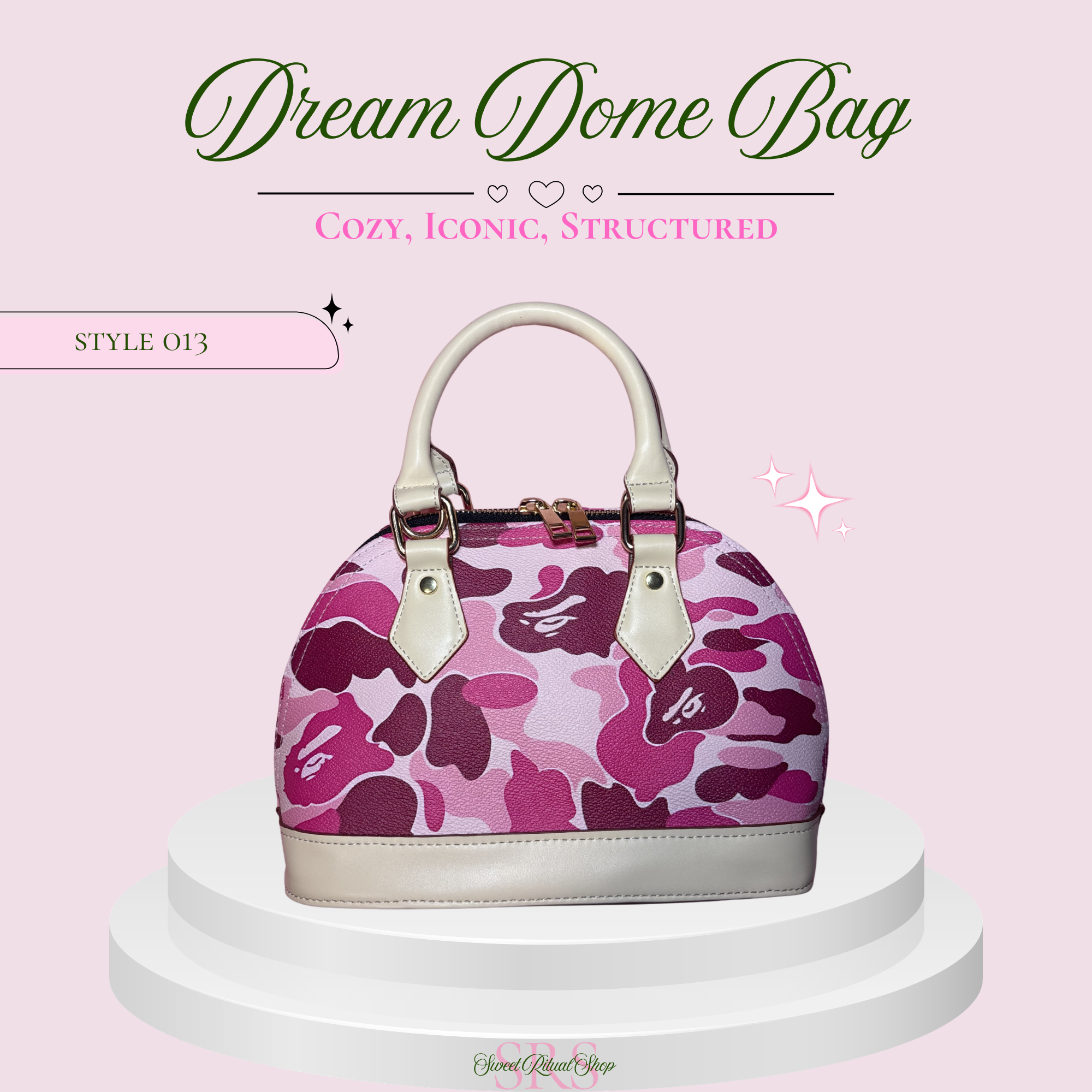 A structured dome-shaped handbag with a pink and purple camouflage pattern, displayed on a white tiered pedestal against a light pink background with promotional text.