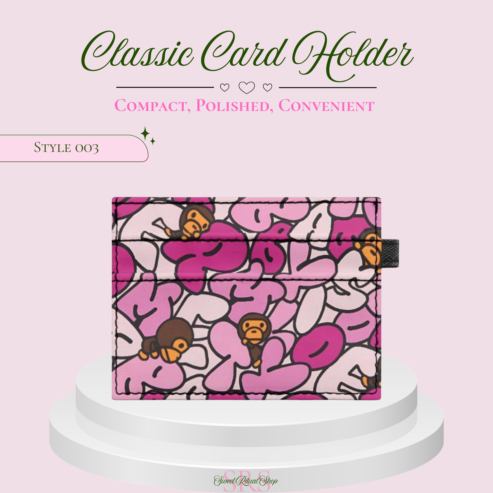 A pink and white patterned card holder wallet with cartoon monkey graphics, displayed on a white tiered pedestal against a light pink background with promotional text.